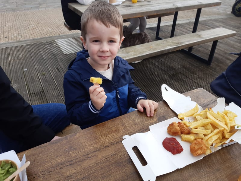Luke Whitehead, 3, tucks into his chips.