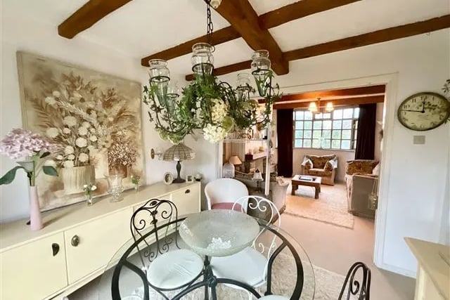 The dining room and living room are connected and flow into one another. Perhaps the small partition walls can be removed to make one expansive room?