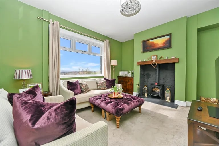 Enter into the home where a charming lounge with log burner awaits.