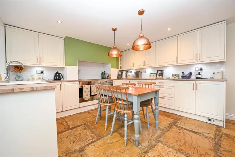 Down the stairs to the lower ground floor is a stylish kitchen equipped with integral appliances.