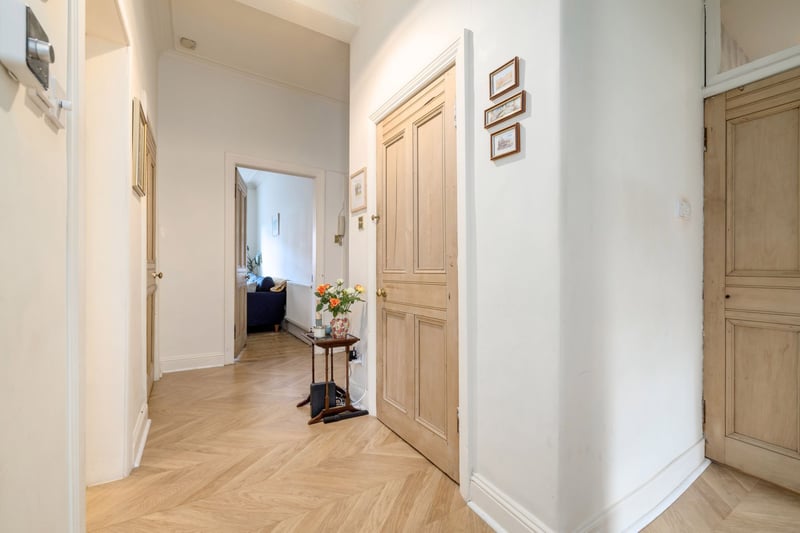 The hallway, with a large walk-in cupboard, which could make a handy study space or storage, together with a utility cupboard with shelving for linens.