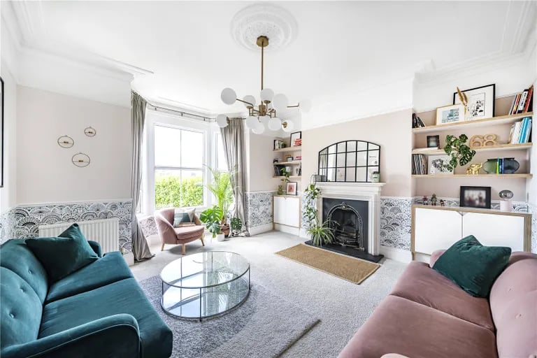 On the ground floor are two magnificent reception rooms, this one with feature fireplace and bay window overlooking the front garden.