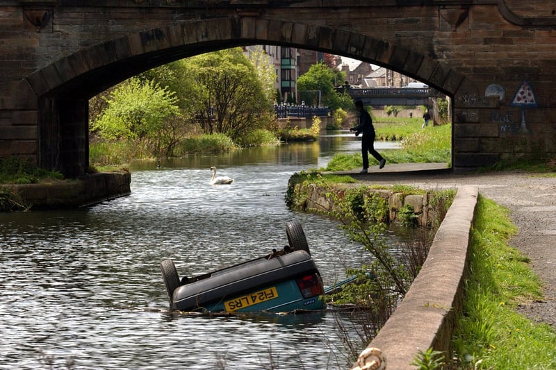 An abandoned car lies in the Union Canal near the Fountain Brewery in Edinburgh in May, 2002.