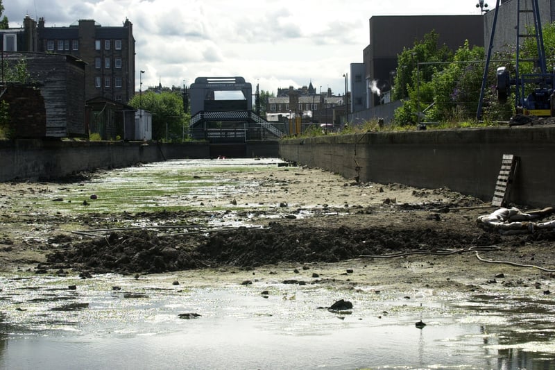 An empty Lochrin Basin in Fountainbridge in July 2002 thanks to excavation works. The basin, which forms one end of the Union Canal, accidentally drained on the 23rd of June, flooding into local streets to the north of the canal.