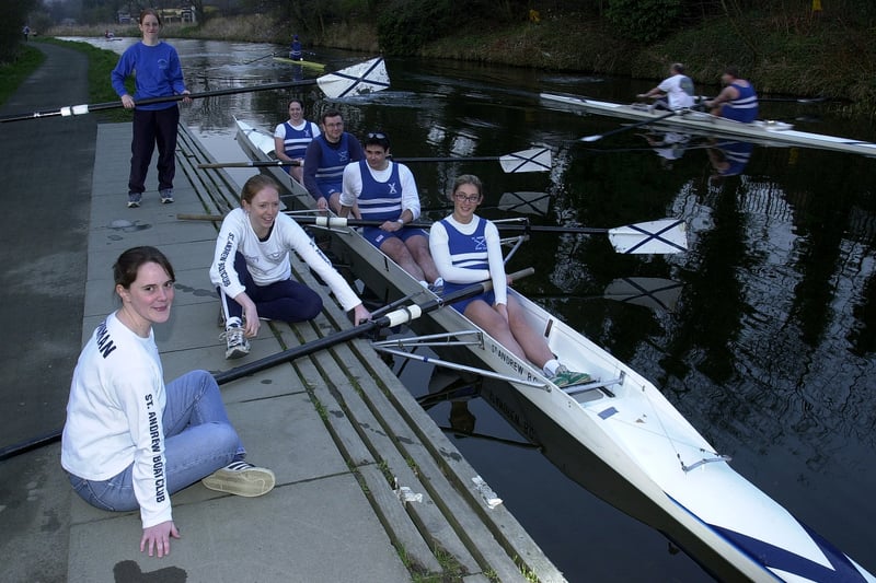 Members of the St. Andrew's Rowing Club (clockwise) Coxain Jo Wherrit (standing), Mairi Torrie, Ian Johnston, John Seton, Michele Jowitt, Cal Bowman (nearest) and Viv Samuelson on the Union Canal at the Meggetland, Edinburgh; April 3, 2002.