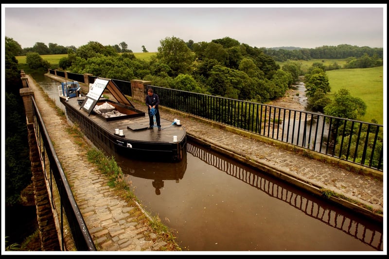 Crossing the Almond Aqueduct on the Union Canal between Ratho and Broxburn, a British Waterways barge transports the first freight transport for some 70 years along the canal en route from Edinburgh to Glasgow.
