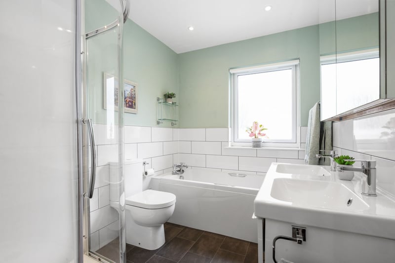 The family bathroom, consisting of a stylish suite and separate shower enclosure. 