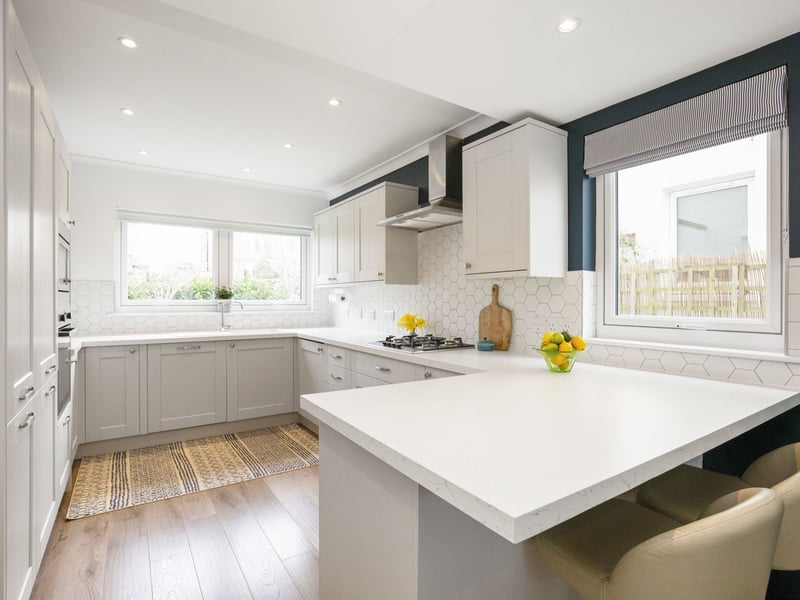 The superbly appointed open plan kitchen/dining falling naturally into two defined areas and complemented by integrated appliances.