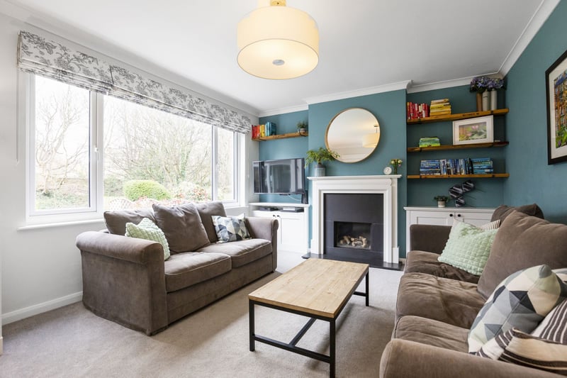 The charming living room, featuring a handsome gas fire.