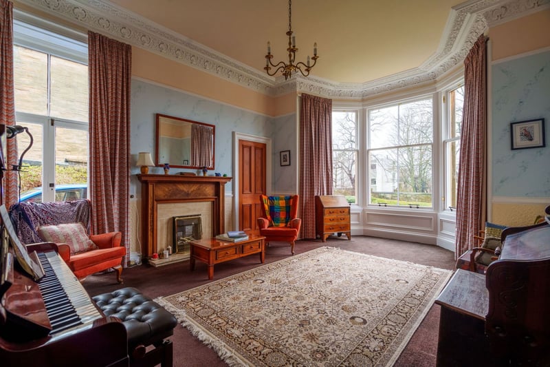 On the ground floor, in the original part of the home, there is a traditional bay windowed living room with ornate cornicing, Edinburgh press, fireplace with working electric fire and side access door. 