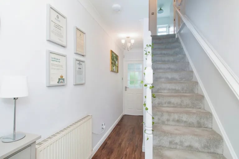 Enter into an inviting hallway with stairs to the top floor.