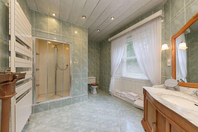 The property boasts three bathrooms, including an ensuite from the main bedroom and a family bathroom.
