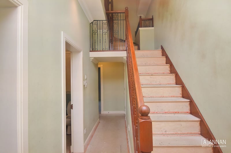 The welcoming entrance hall has handy under stair storage, and the feature staircase leading up to the upper landing.