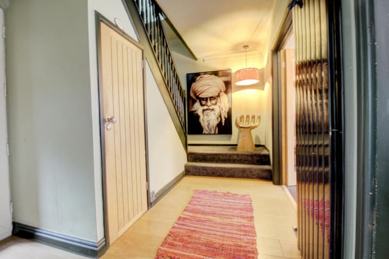 The hallway leading up to the first floor features lots of handy storage space.