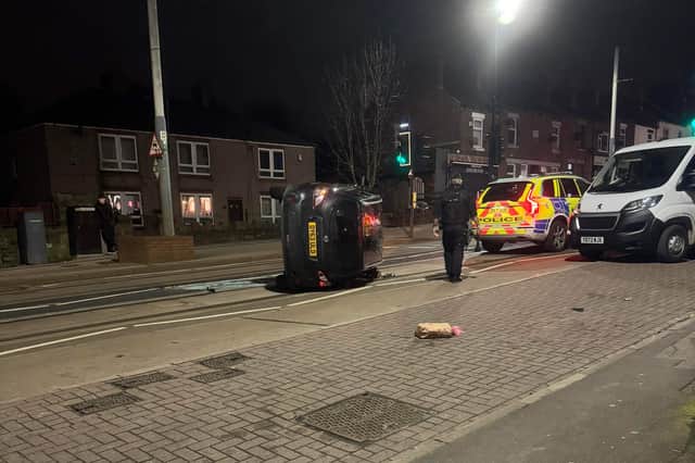 Car on its side on City Road, Sheffield (Photo and video: Nathan Gornall)