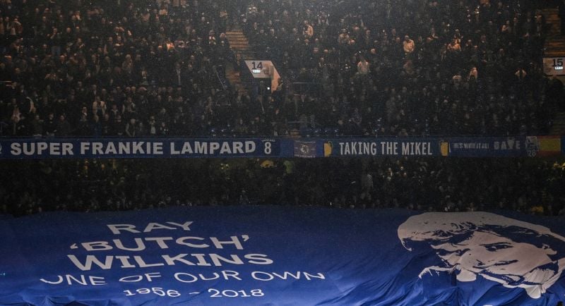 Chelsea's supporters hold a banner picturing late Chelsea's player Ray Wilkins