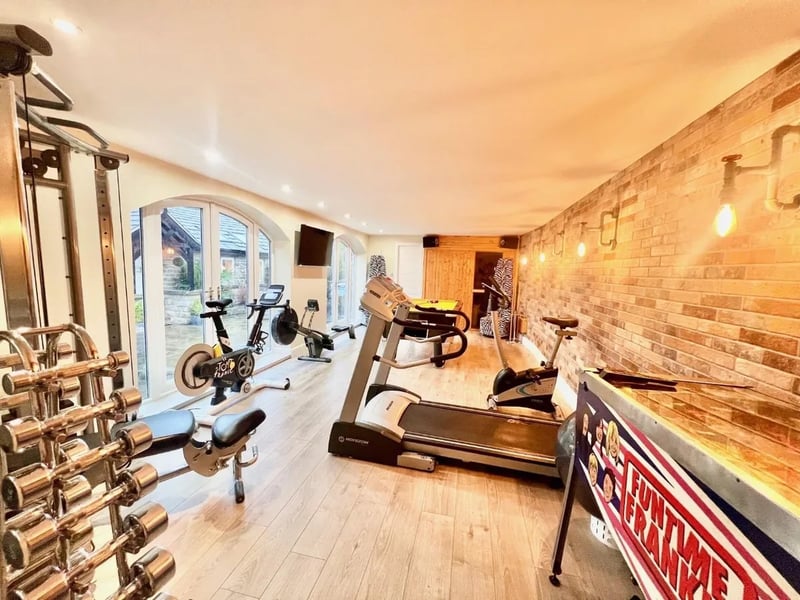 There is plenty of space in the home gym for a lot of exercise equipment. A sauna is located at the end.
