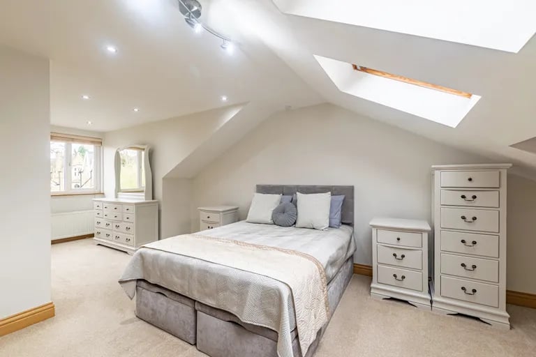 On the top floor is the super-sized primary bedroom with stylish skylights.