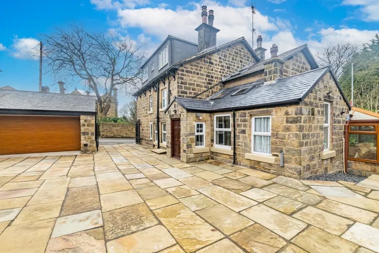 Externally, secure metal gates leads you into this spacious Yorkshire stone-flagged driveway and double detached garage.