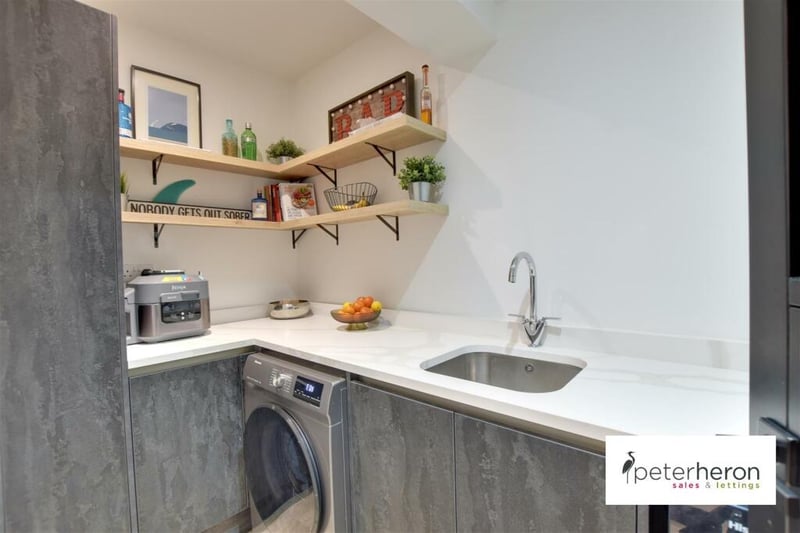The utility room features the same worktops and cupboards as the kitchen, providing more space for the family.