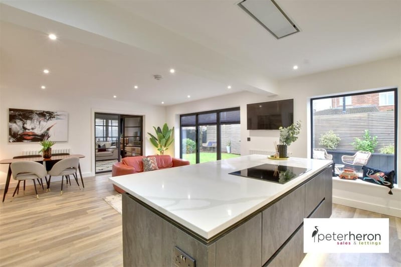 The property's kitchen is described as a "bespoke" fitted kitchen with integrated appliances and quartz worktops.
