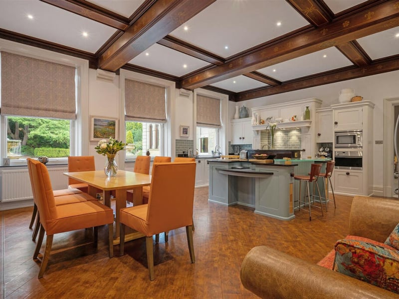 Wooden beams in the kitchen are a nod to the country cottage theme