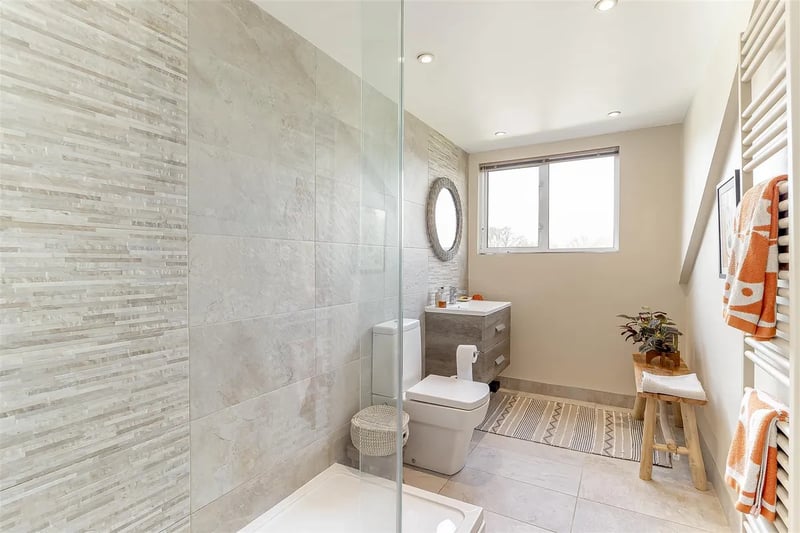 The modern house bathroom offers luxury in the form of a large walk-in shower.