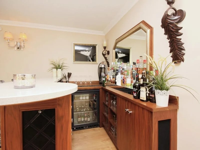 At one end of the sitting room is a well-equipped bar area.