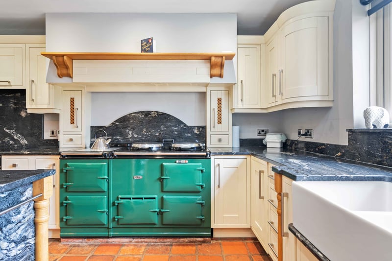The spacious kitchen is the beating heart of this family home, and comes complete with Aga and large island, leading into the dining area, while the oak framed orangery provides a serene retreat.