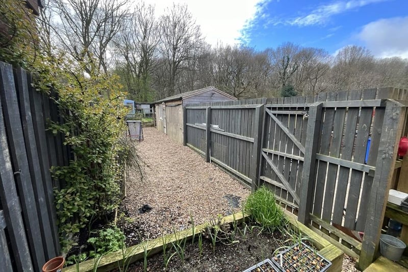 The area alongside the office from the house, leading to the lawn and vegetable patch, could be converted into a patio or extension of the lawn.