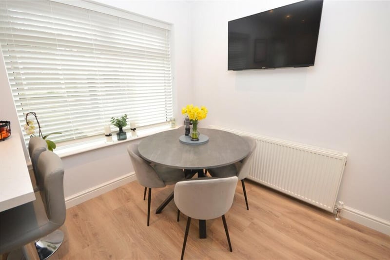The dining area sits right by a large window overlooking the rear garden.