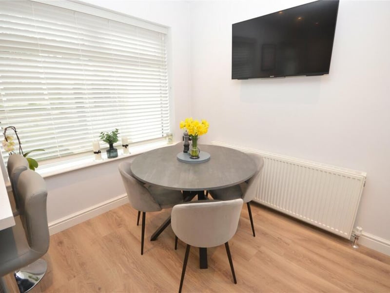 The dining area sits right by a large window overlooking the rear garden.