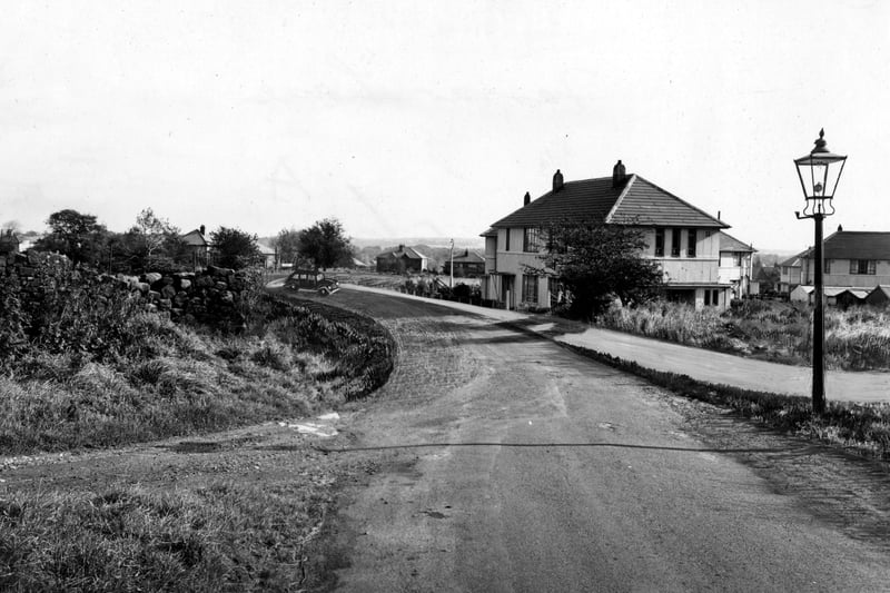 A view looking east down Farrar Lane. A lamp post is to the right in front of some houses. The photo has been altered to show proposed road widening. Pictured in October 1951.