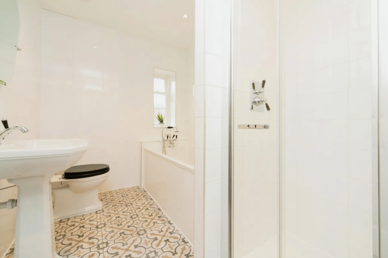 Four piece bathroom suite with integrated bath, separate shower, toilet & wash basin.