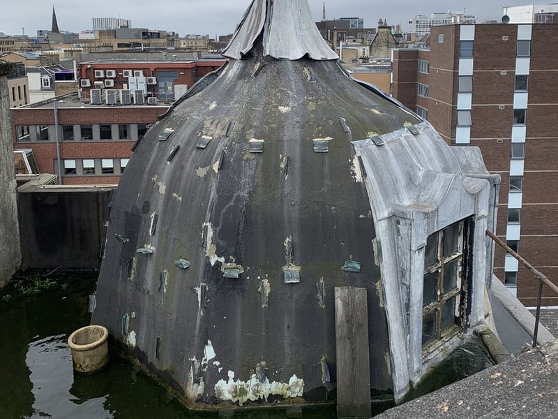 The distinctive turret feature on the roof of the building.