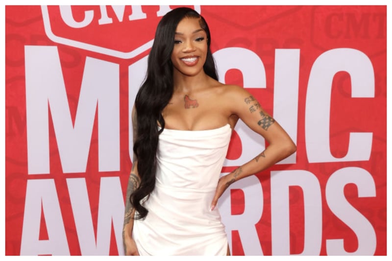 Rapper GloRilla was undoubtedly one of the best dressed at the 2024 CMT Music Awards. She opted for a white corset gown with a thigh-high split that she paired with gladiator style stilettos. GloRilla kept her hair long and opted for waves with a side parting