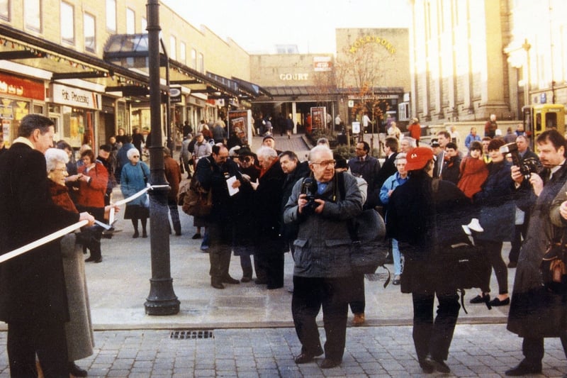 Crowds are gathered on Queen Street and Windsor Court at the opening of the pedestrianisation scheme for Queen Street in December 1995. Councillor Linda Middleton, on the left, is about to cut the tape.