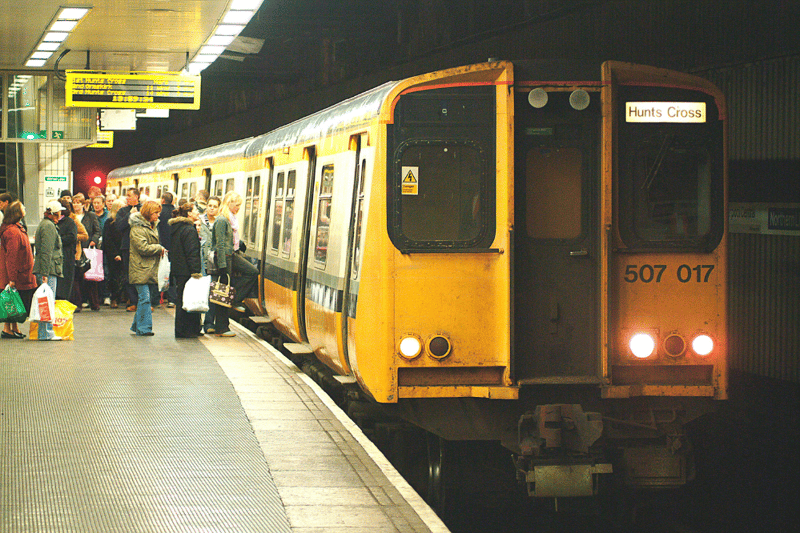 Passengers board a Merseyrail train to Hunts Cross from Liverpool Central in November 2003.