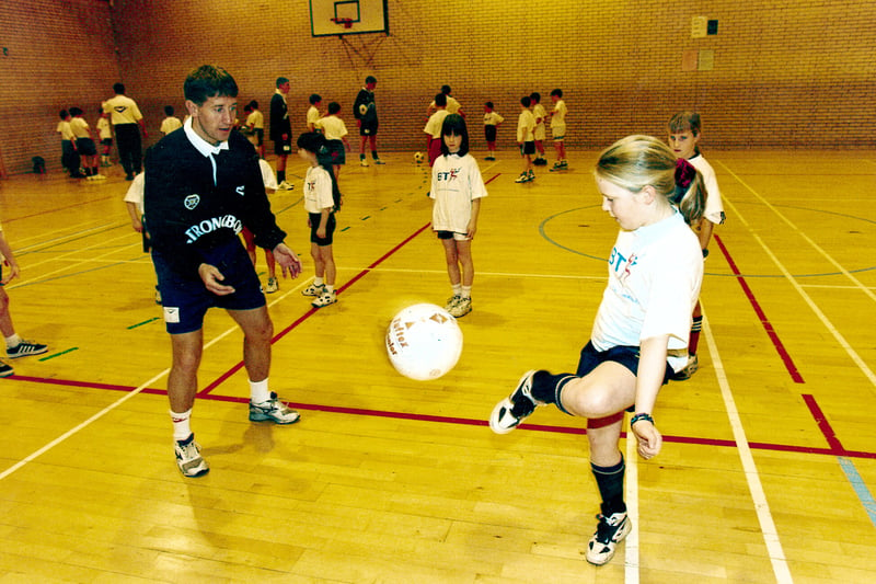 Tynecastle High School pupil Elizabeth Malcolm shows off her football skills to Hearts' striker John Robertson in December, 1996. The Hearts all-time leading goalscorer netted an incredible 212 goals in two spells for the Jambos.