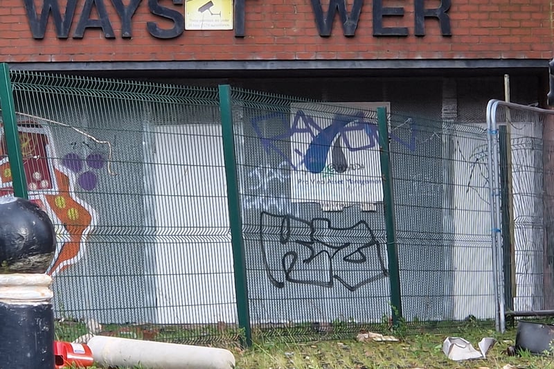 Fences are displayed for the tower block’s protection, yet graffiti is evident.