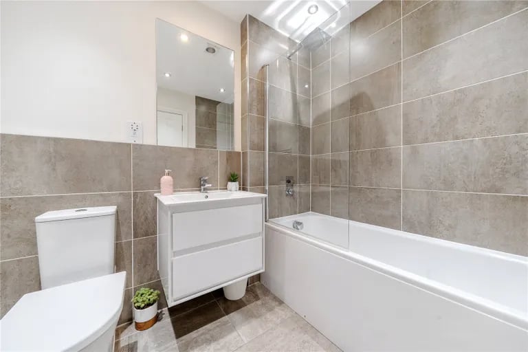 The property has a total of two en-suites, a guest WC and this house bathroom with bathtub.