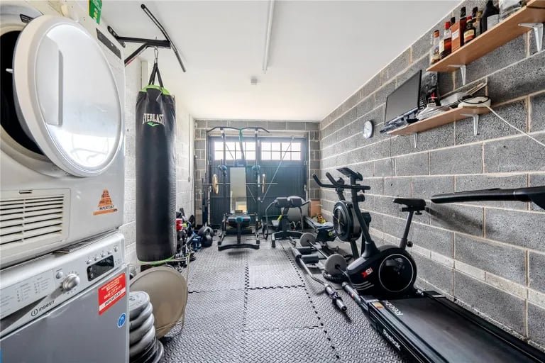 There is an integrated single garage currently used as a home gym.