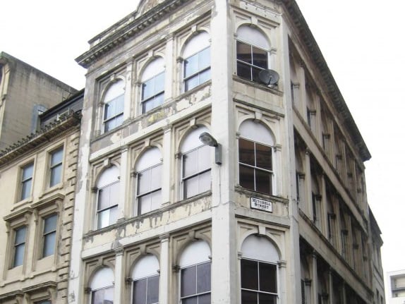 Found at the bottom of Mitchell Street, the Renaissance style four-storey building appears to remain unused in the upper floors. It was repainted externally almost five years ago with vegetation now beginning to appear on the roof. 