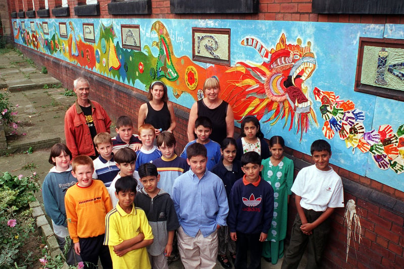 Pupils are pictured in September 1999 with a new school mural that was painted with the help of Hyde Park Source. 