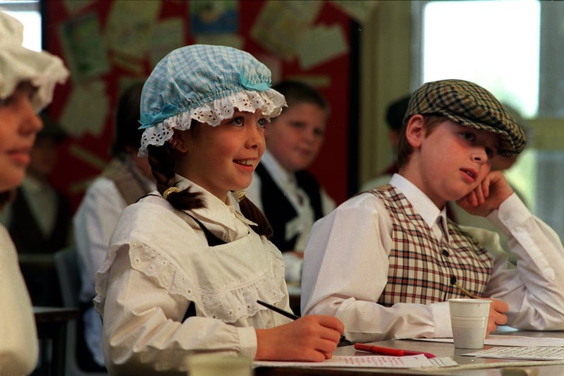 Pupils dressed up in period costume as part of their Victorian history topic organised by teacher Anne Pilkington in October 1999. Pictured rare Isabelle Mason and Kieran Tate during one of the lessons. 