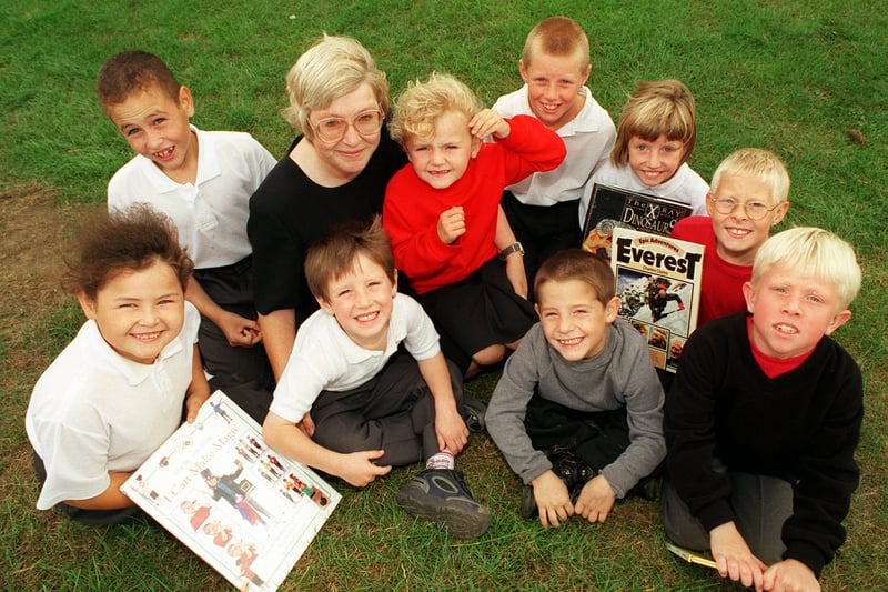 Headteacher Ann Tomkins with pupils who did not miss a day's attendance during all the last school year. They were   and were rewarded with tokens for books. Pictured in September 1999.
