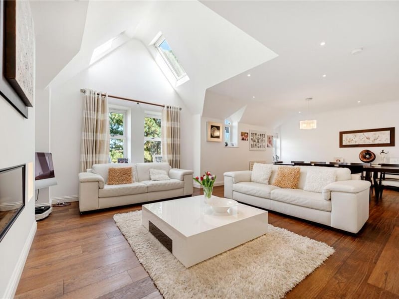 Here is a remote controlled gas fireplace, elegant wood flooring and skylights letting in lots of natural light.