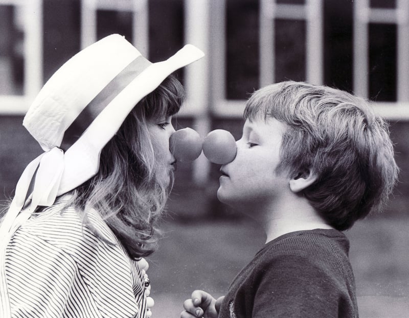 Helen Clarke (8) and Darren Hague (6) come nose to nose at Woodthorpe School in March 1989 for Red Nose Day