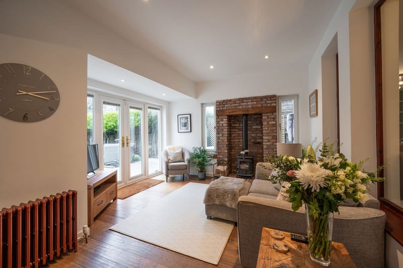 The comfortable sun room off the kitchen/dining room provides direct access to the private rear garden via double fully glazed French patio doors.