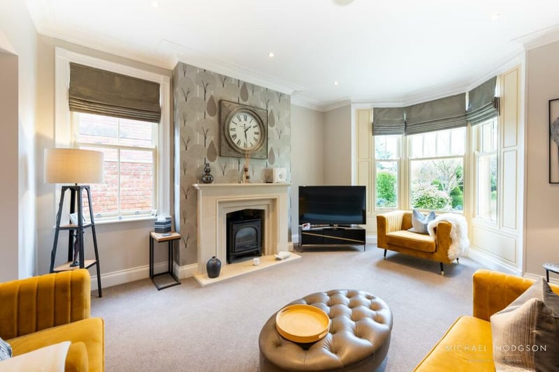 The sitting room is well lit with a huge bay window, perfect for hosting family and friends.